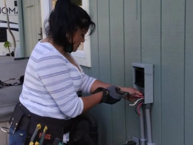 Licensed electrician wiring an exterior subpanel in Vernon